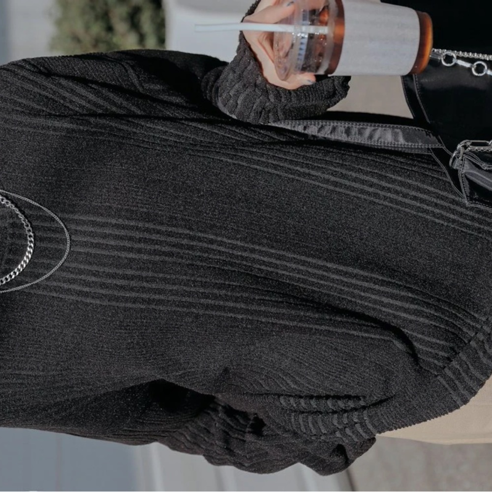 Dazy ribbed knit drop shoulder tee in the color black.
